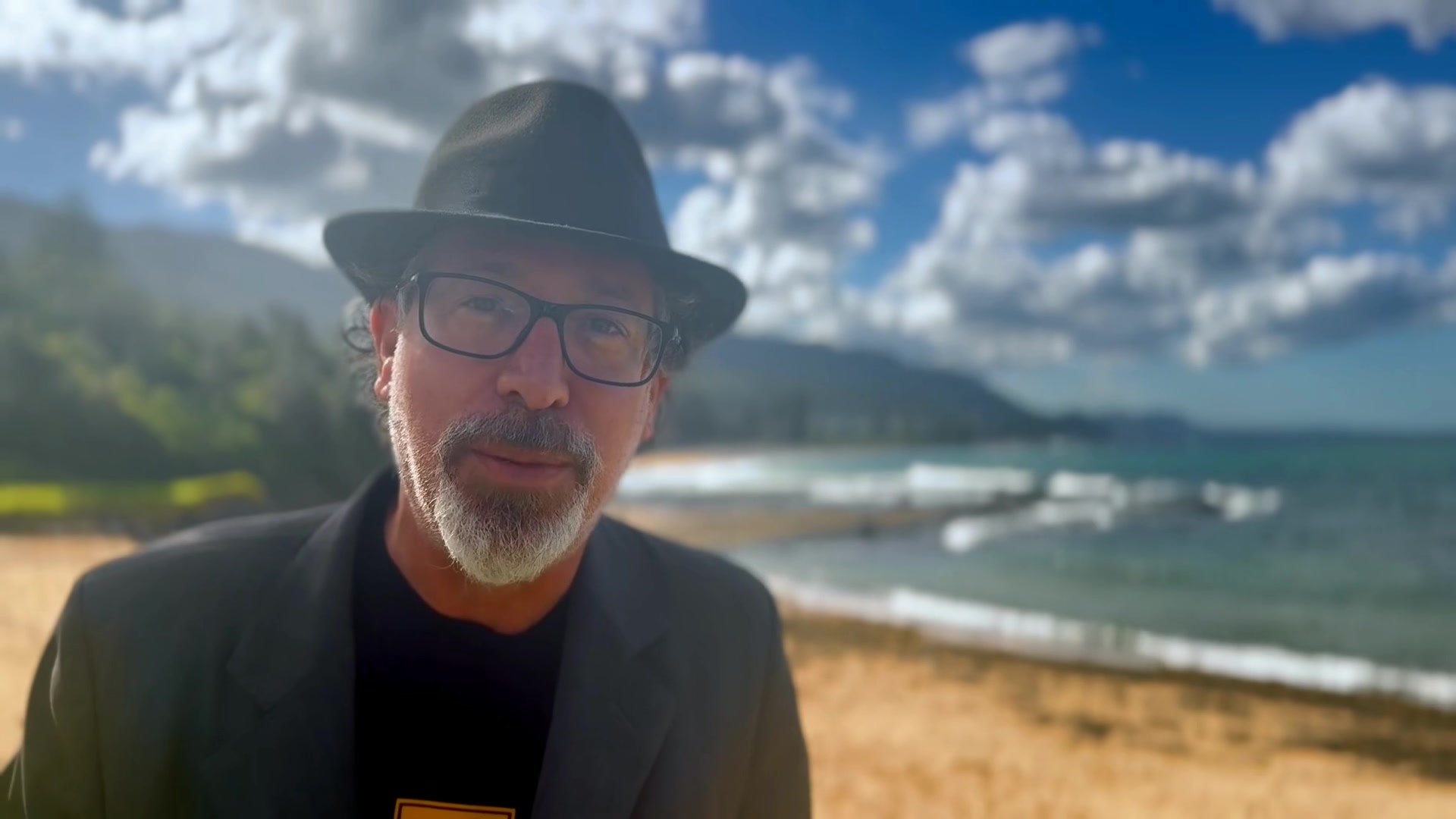 Benjamin Rose outdoors by the water, in a still from his free digital-story invitation.